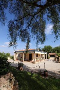 a large building with a patio in front of it at Spacious Villa with Pool in Sanlúcar la Mayor in Sanlúcar la Mayor