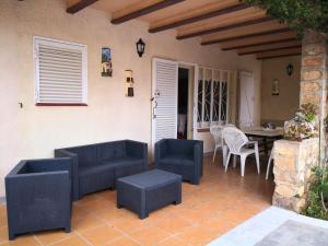 a patio with couches and a table and chairs at Seaside Villa in Calafat with Private Pool. in Calafat