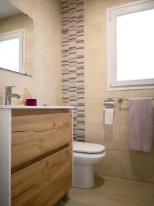 a bathroom with a toilet and a sink and a window at Seaside Villa in Calafat with Private Pool. in Calafat +21 photos