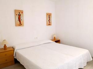 a bedroom with a white bed and two night stands at Seaside Villa in Calafat with Private Pool. in Calafat