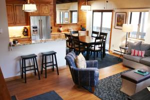 a living room and kitchen with a table and chairs at Vail Racquet Club Mountain Resort in Vail