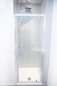 a shower with a glass door in a bathroom at The Neuk Anstruther Sleeps 6 Fantastic Location in Anstruther
