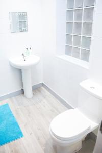 a white bathroom with a toilet and a sink at The Neuk Anstruther Sleeps 6 Fantastic Location in Anstruther
