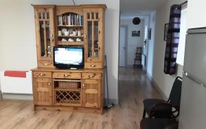 een tv op een houten kast in een kamer bij Cosy 2-Bed Cottage in Sligo in Enniscrone