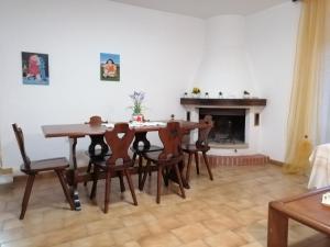 a dining room with a table and chairs and a fireplace at La casa di Piera in Riccò del Golfo di Spezia +28 photos