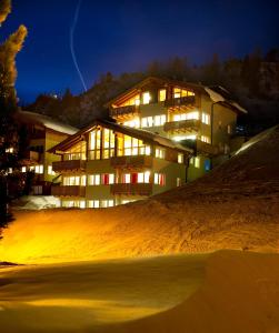 a building on top of a hill at night at Obertauern Alps in Obertauern