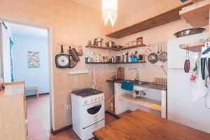 a kitchen with a white stove and a refrigerator at Casa Tabanka Apartment in Tarrafal