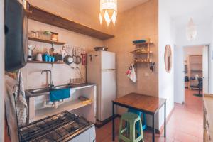a small kitchen with a sink and a refrigerator at Casa Tabanka Apartment in Tarrafal +22 photos