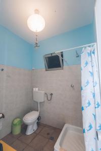 Casa Tabanka Apartment في تارافال: حمام به مرحاض وسقف أزرق