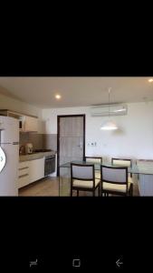 a kitchen with a table and chairs and a refrigerator at WATER FRONT in Maceió