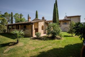 una gran casa de piedra con árboles en un patio en Tenuta Tegolato, en Barberino di Val d'Elsa