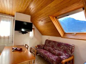 a living room with a couch and a table and a window at Casa Campolé in San Juan de Plan