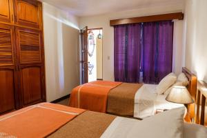 A bed or beds in a room at Hotel San Jorge by Porta Hotels
