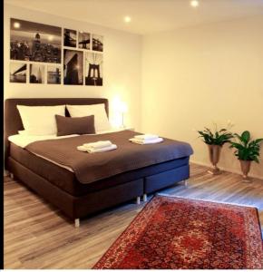 a bedroom with a large bed with a rug at Ferienwohnung Roxana - am Bodensee in Friedrichshafen