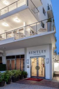 a building with the entrance to a building with plants at Bentley Hotel South Beach in Miami Beach