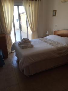 a bedroom with a bed with towels on it at Beautiful spacious 2-Bed Apartment in Xylofagou in Xylophaghou