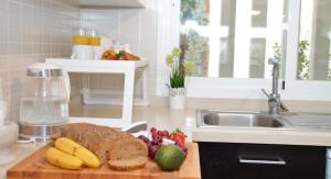 a kitchen counter with a cutting board with a loaf of bread and fruit at Pool- AirCon- Quiet&Peaceful- FamilyFriendly in Manilva