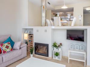 a living room with a couch and a fireplace at Pool- AirCon- Quiet&Peaceful- FamilyFriendly in Manilva