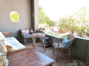 a room with chairs and a table and a window at Cosy 6 Person Cottage with Mountain View in Barrydale