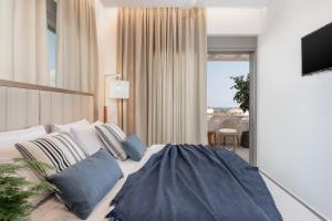 A bed or beds in a room at Anthos Villas - Chania