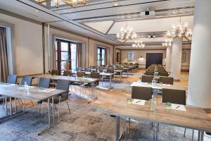 a large room with tables and chairs and a stage at Steigenberger Hotel Conti Hansa Kiel in Kiel