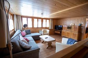 a living room with a couch and a table at Alpensonne in Reckingen - Gluringen