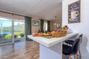 a kitchen with a counter with fruit on it at Apartman ELLA in Peračko Blato