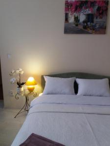 a bedroom with a large white bed with a lamp at Центрові апартаменти in Ivano-Frankivsk