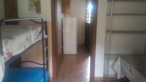 Zimmer mit einem Etagenbett und einem Kühlschrank in der Unterkunft Michelangelo's House in Gioiosa Marea