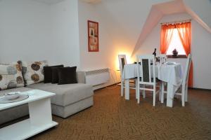 a living room with a couch and a table at Apartmani Pavlović in Kopaonik