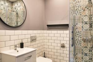 a bathroom with a toilet and a sink and a shower at Pośród Drzew Studio Świętojańska Gdynia in Gdynia +9 photos