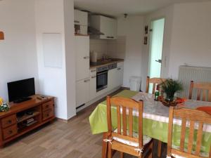 a kitchen and dining room with a table and a television at Ferienhaus Brücke in Quedlinburg
