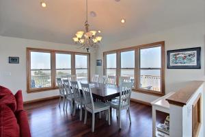 a dining room with a table and chairs and windows at Knock Out #3-MC in Avon +22 photos