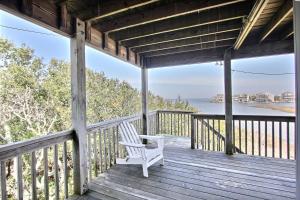 a white chair sitting on a porch with a view of the water at Knock Out #3-MC in Avon