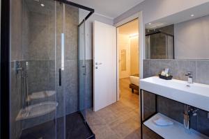a bathroom with a sink and a shower at Albergo Giuan Arma di Taggia in Arma di Taggia +17 photos