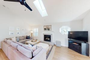 a living room with a couch and a fireplace at The Surfbird in Pacific City