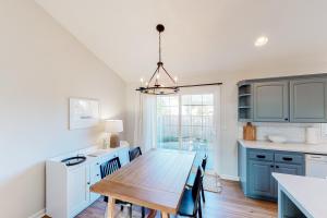 a kitchen with a wooden table and a dining room at The Surfbird in Pacific City