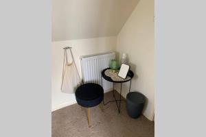 a corner of a room with a table and a stool at The Annex @ 3 East Town Cottages in West Ashton