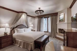 a bedroom with a large bed and a large window at The Arrabelle at Vail Square, a RockResort in Vail