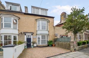 a brick house with a blue door at The Grange in Weymouth