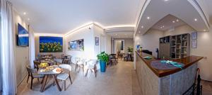a kitchen and dining room with a table and chairs at Albergo Giuan Arma di Taggia in Arma di Taggia