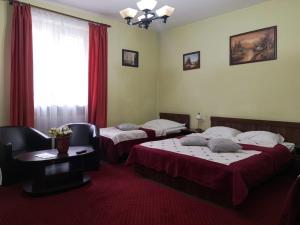ein Hotelzimmer mit 2 Betten und einem Tisch in der Unterkunft Villa Casa Ioana in Braşov