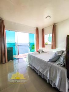 a bedroom with a bed with a view of the ocean at SUN7 in Morro de São Paulo +64 photos