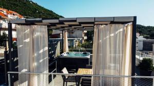 a pergola with a tub on a balcony at Villa Jadran in Promajna