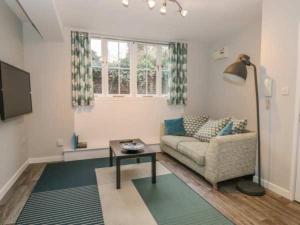a living room with a couch and a table at Remarkable 1-Bed Apartment in Ulverston in Ulverston