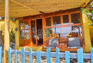 a house with a wooden porch with a fence at Hotel & Restaurante Arca de Noé in Santa Cruz La Laguna