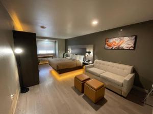 a hotel room with a bed and a couch at Quality Inn & Suites North Mesquite I-30 in Mesquite