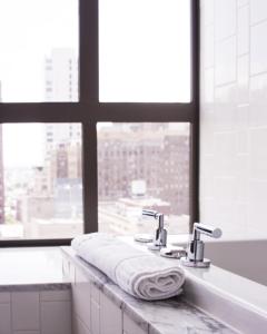 a bathroom with a sink with a towel on it at Kimpton Hotel Palomar Philadelphia, an IHG Hotel in Philadelphia