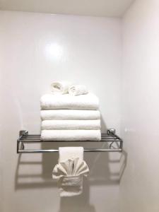 a stack of towels on a towel rack in a bathroom at La Quinta by Wyndham Casper Event Center Area in Casper