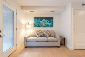 a living room with a couch and a painting on the wall at Basecamp Resorts Revelstoke in Revelstoke
